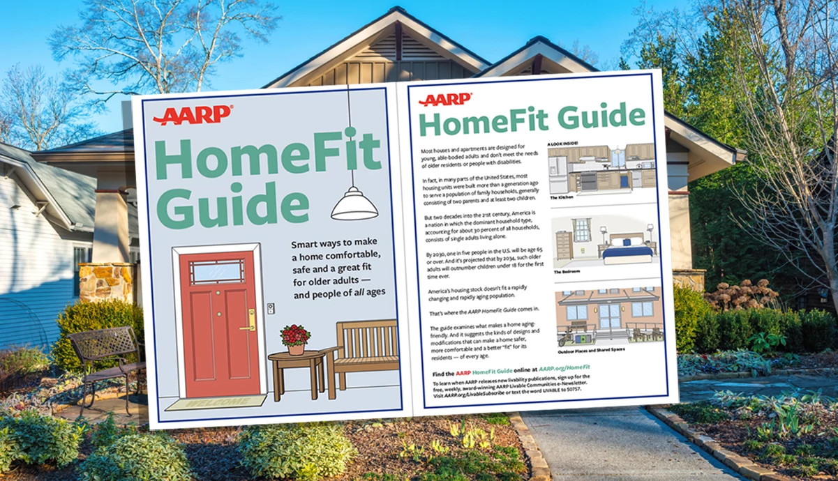 An opened AARP HomeFit Guide superimposed in front of a suburban home with a garden and walkway