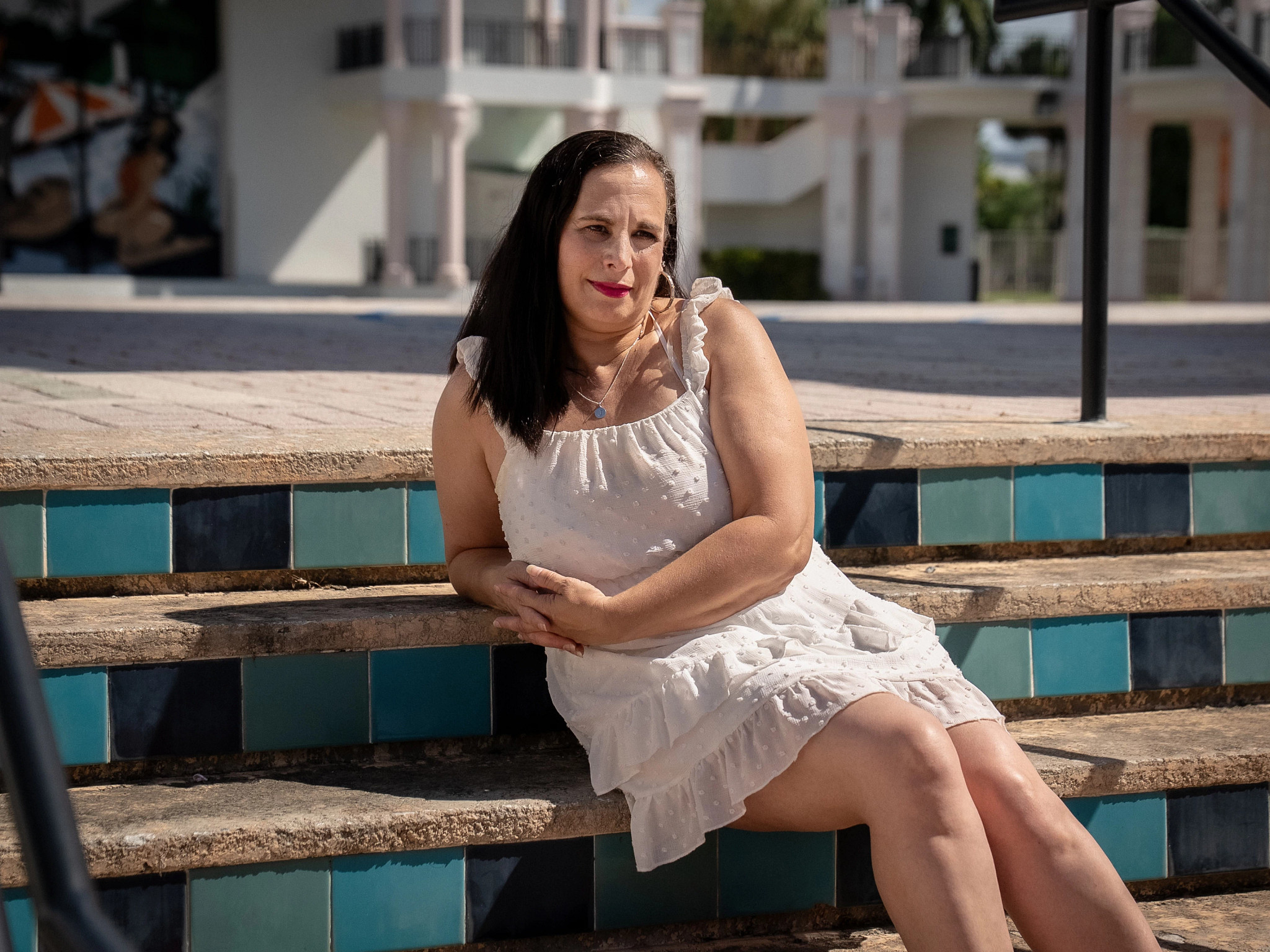 a woman sits on colorful outside steps