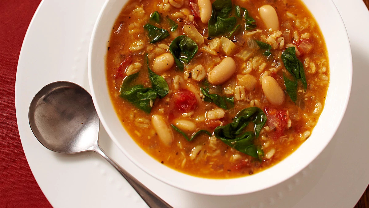 A close-up view of bean and barley soup in a bowl
