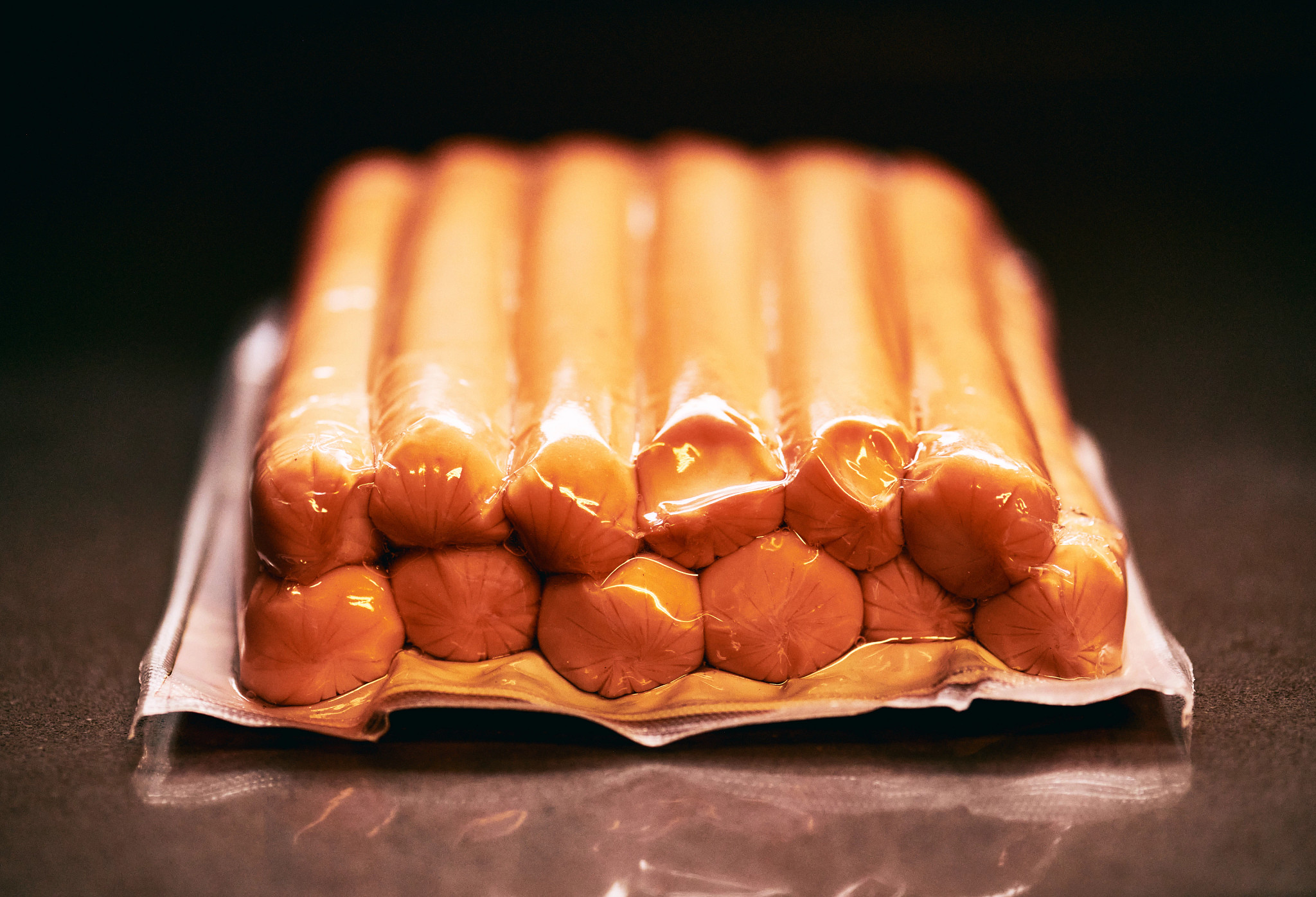 A tightly vacuum-sealed package of sausages