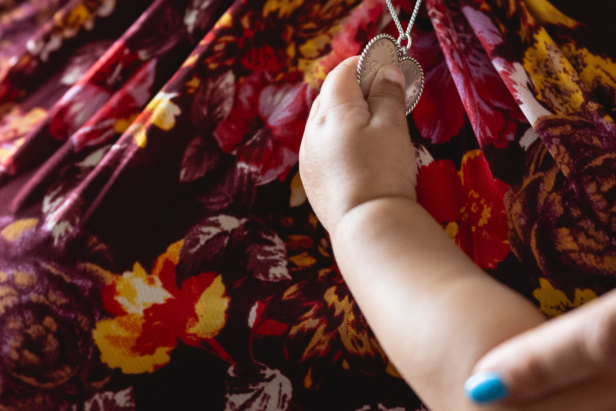 a child holding a piece of jewelry 