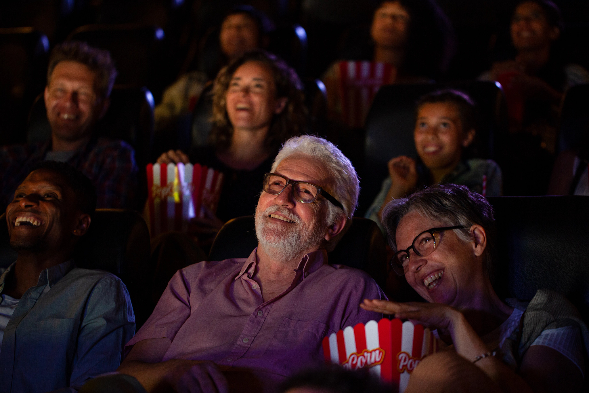 Senior couple having a good time while watching a movie
