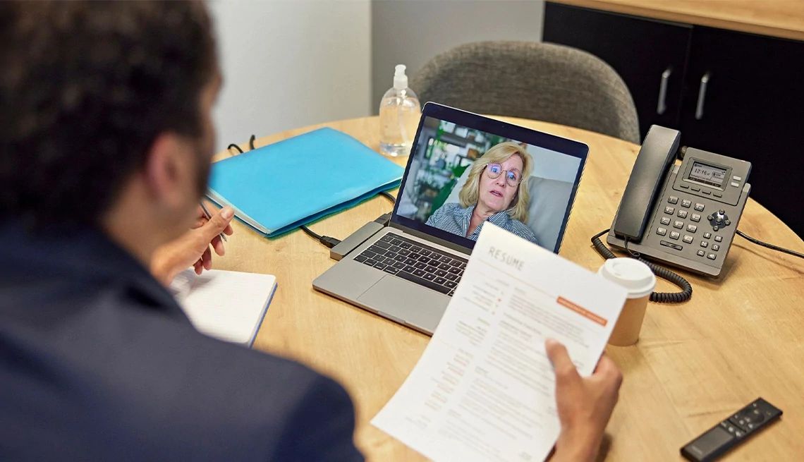 Man meeting virtually with his career coach going over his resume together