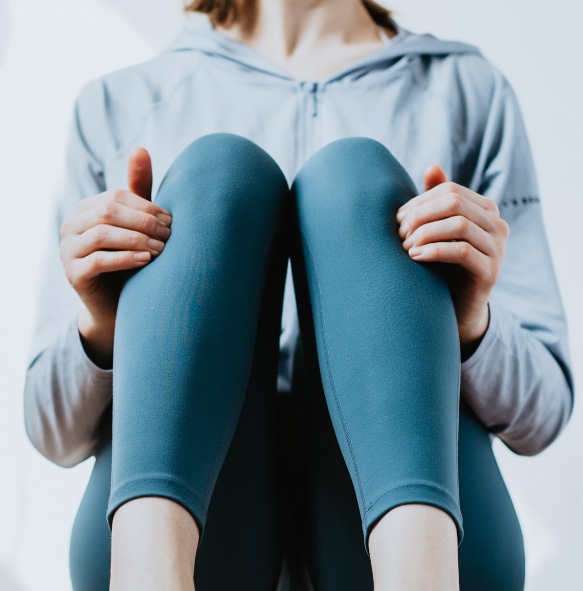a person activating an acupressure point below both knees