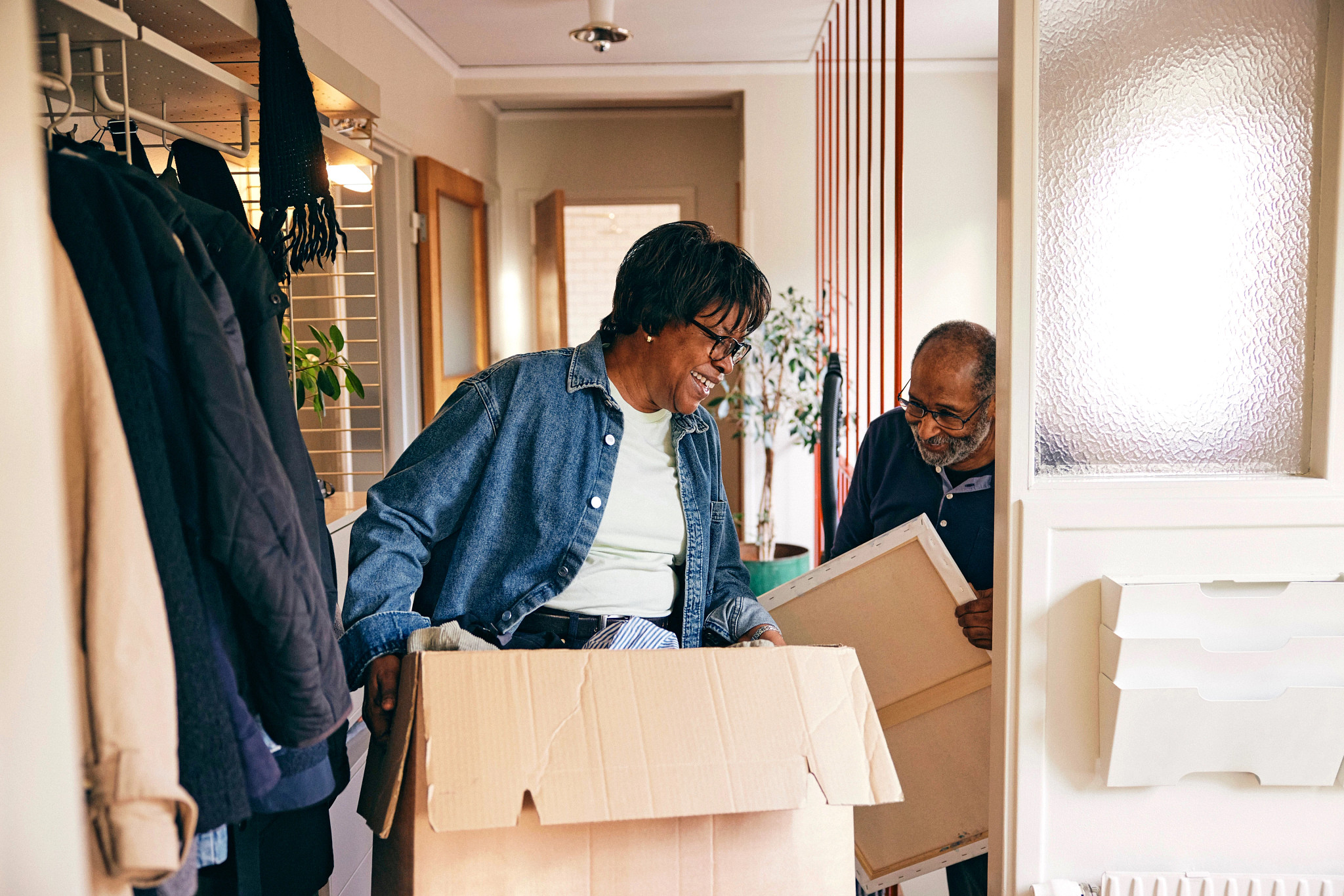 A photo shows an older adult couple moving into a 55-plus community.