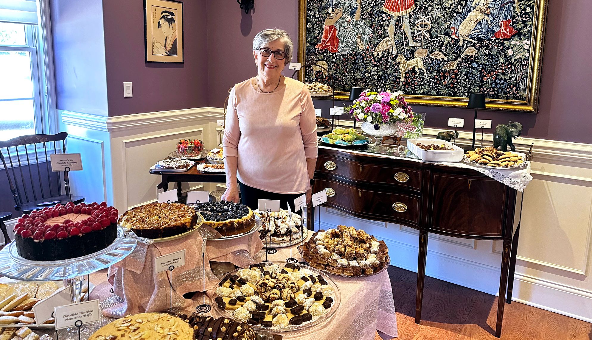 Barbara Beckerman standing next to various baked goods