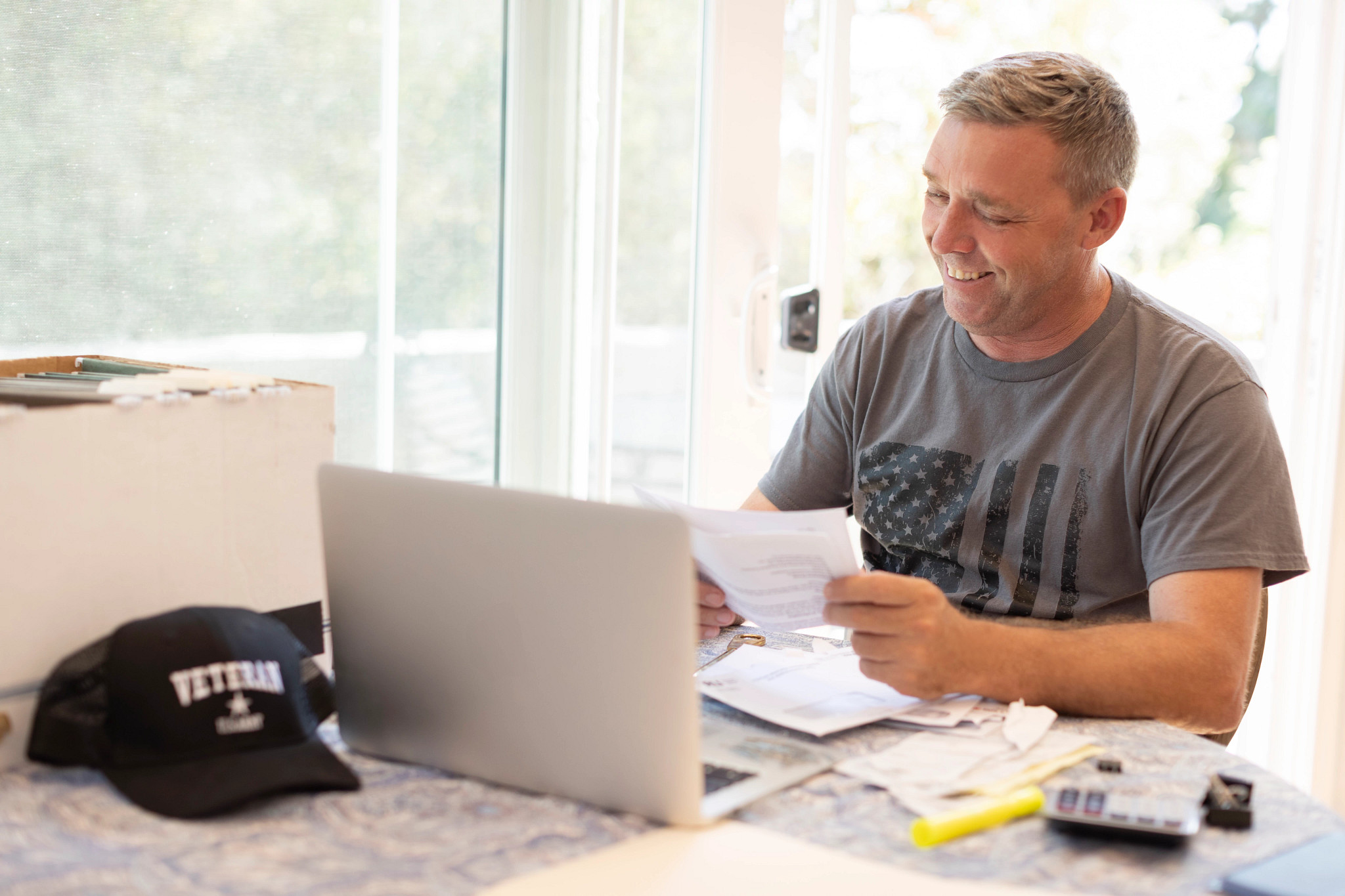 veteran man smiling at his computer