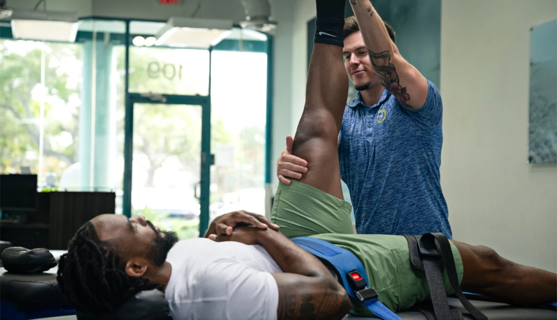 Stretch Zone practitioner stretching a man's leg