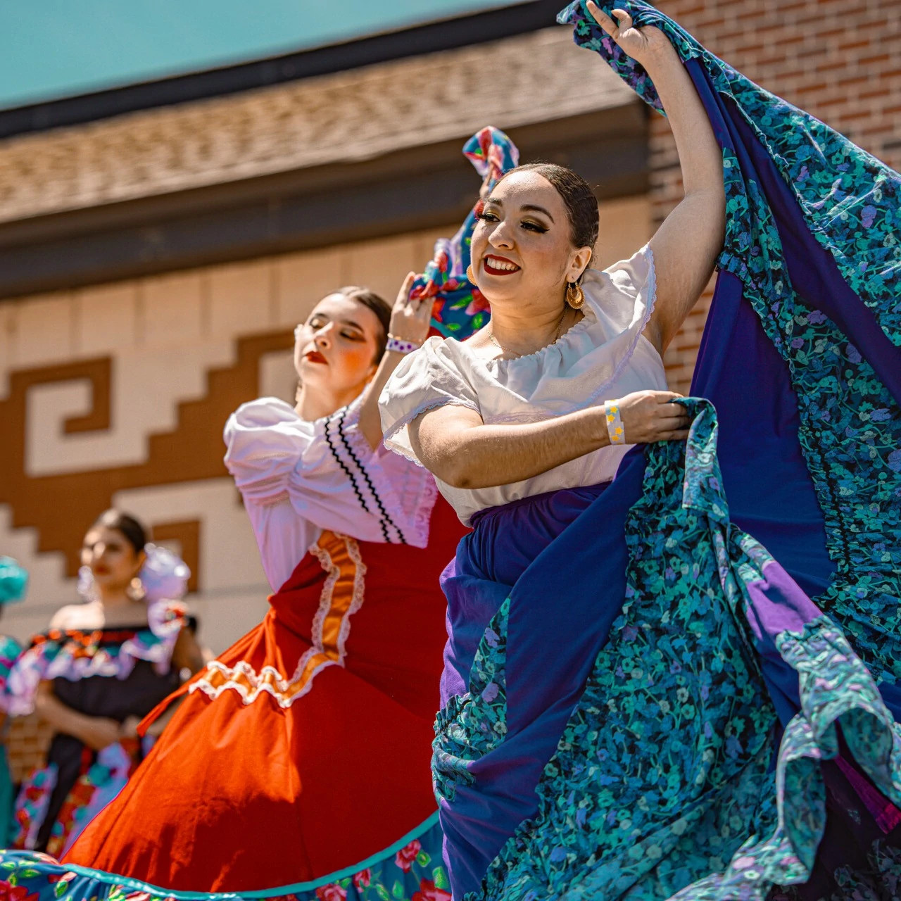 performers in beautfiul dresses dancing