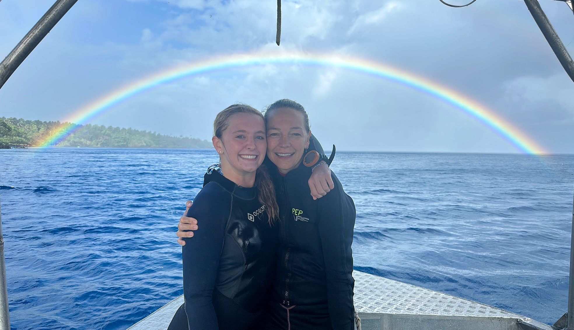 the writer and her niece two people on a boat with a rainbow behind them