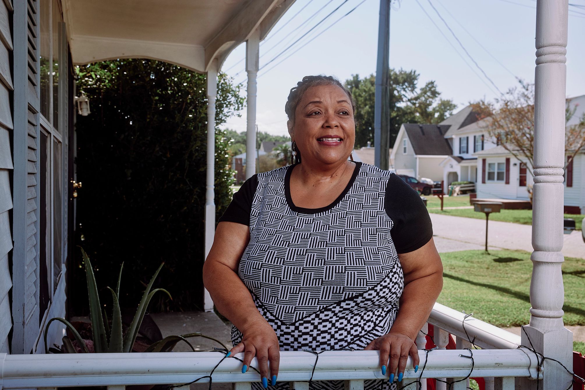 Social Security Benefits and Grandchildren a woman is standing on the porch in at her home