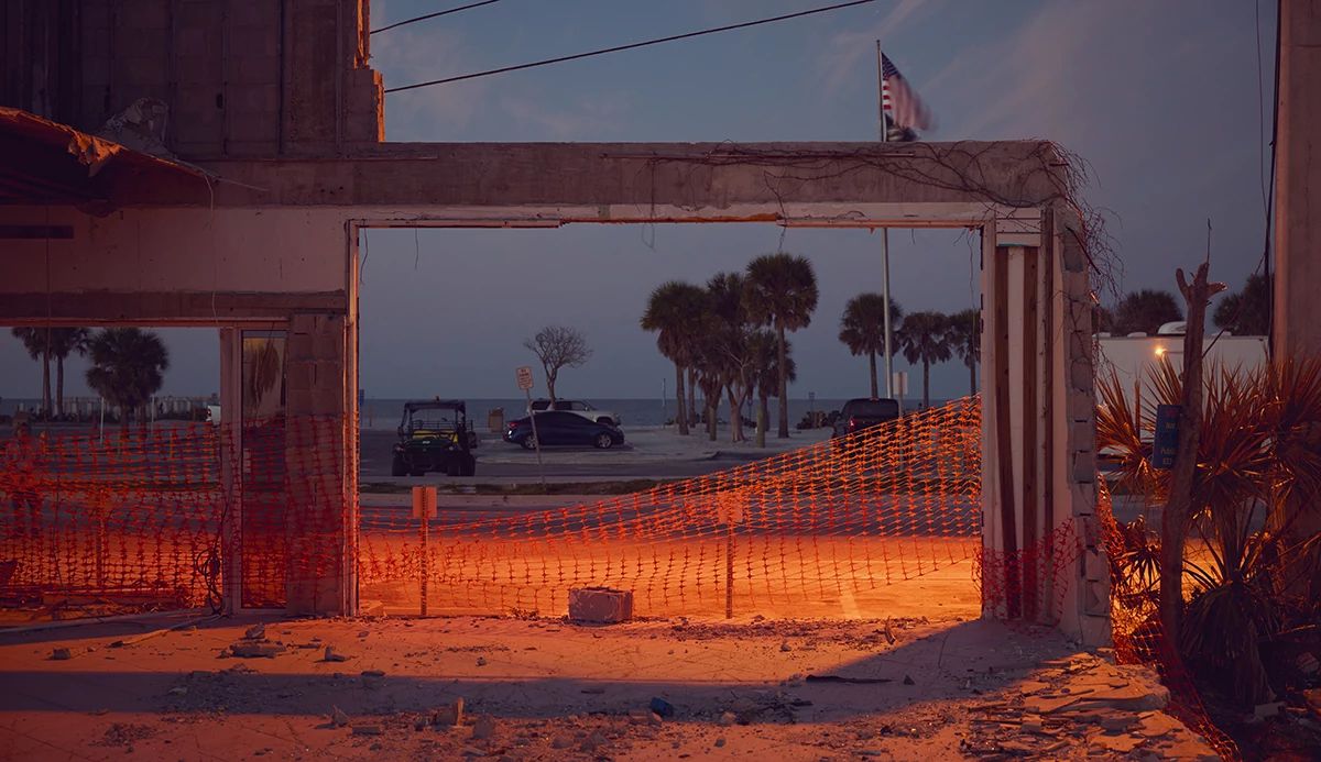 concrete pillars with orange construction fencing