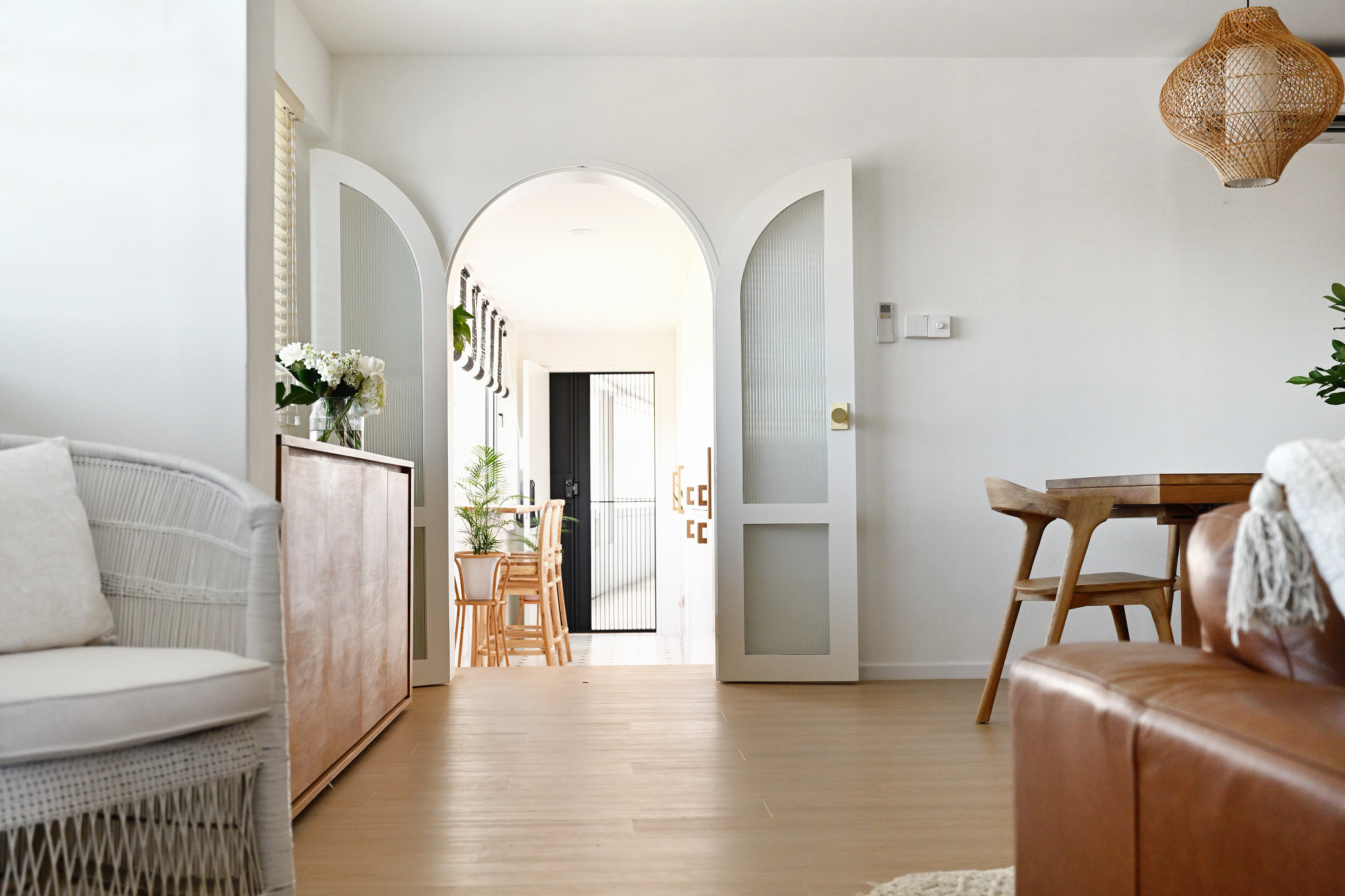 Looking through an arched doorway from inside a homes living room