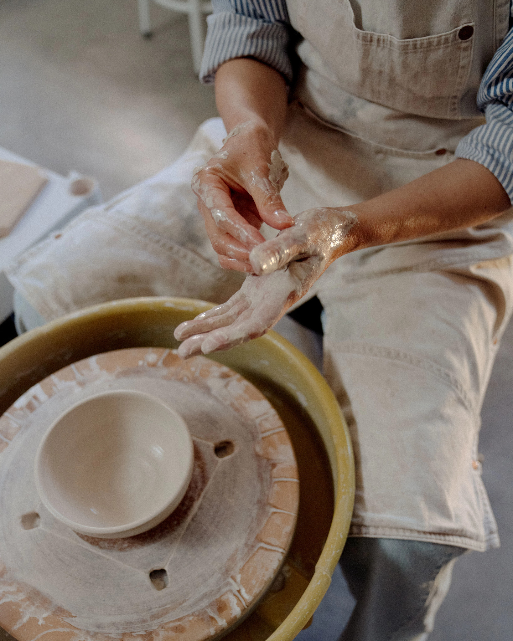 a person working with clay making pottery
