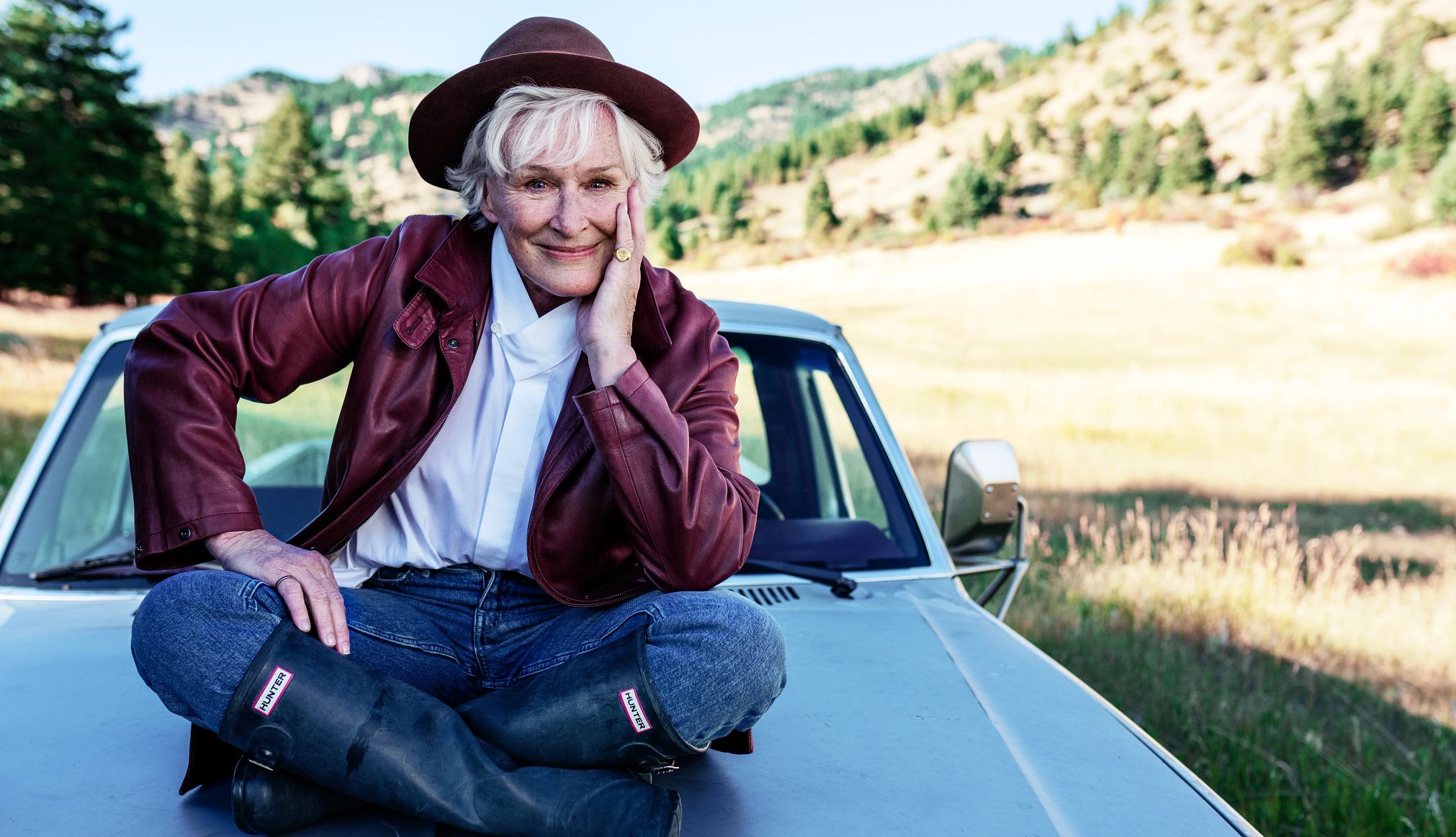 Glenn Close sentada en el capó de su camioneta Ford
