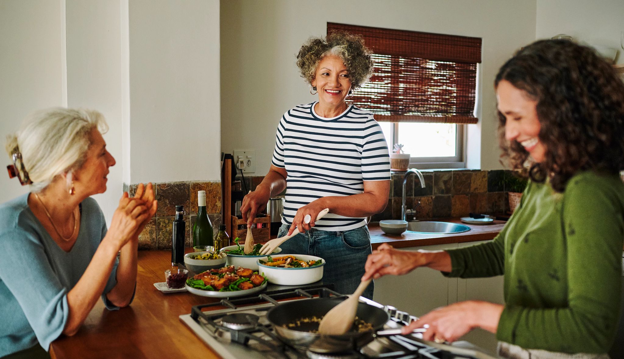 Guide to Buying a Vacation Home people cooking in a kitchen