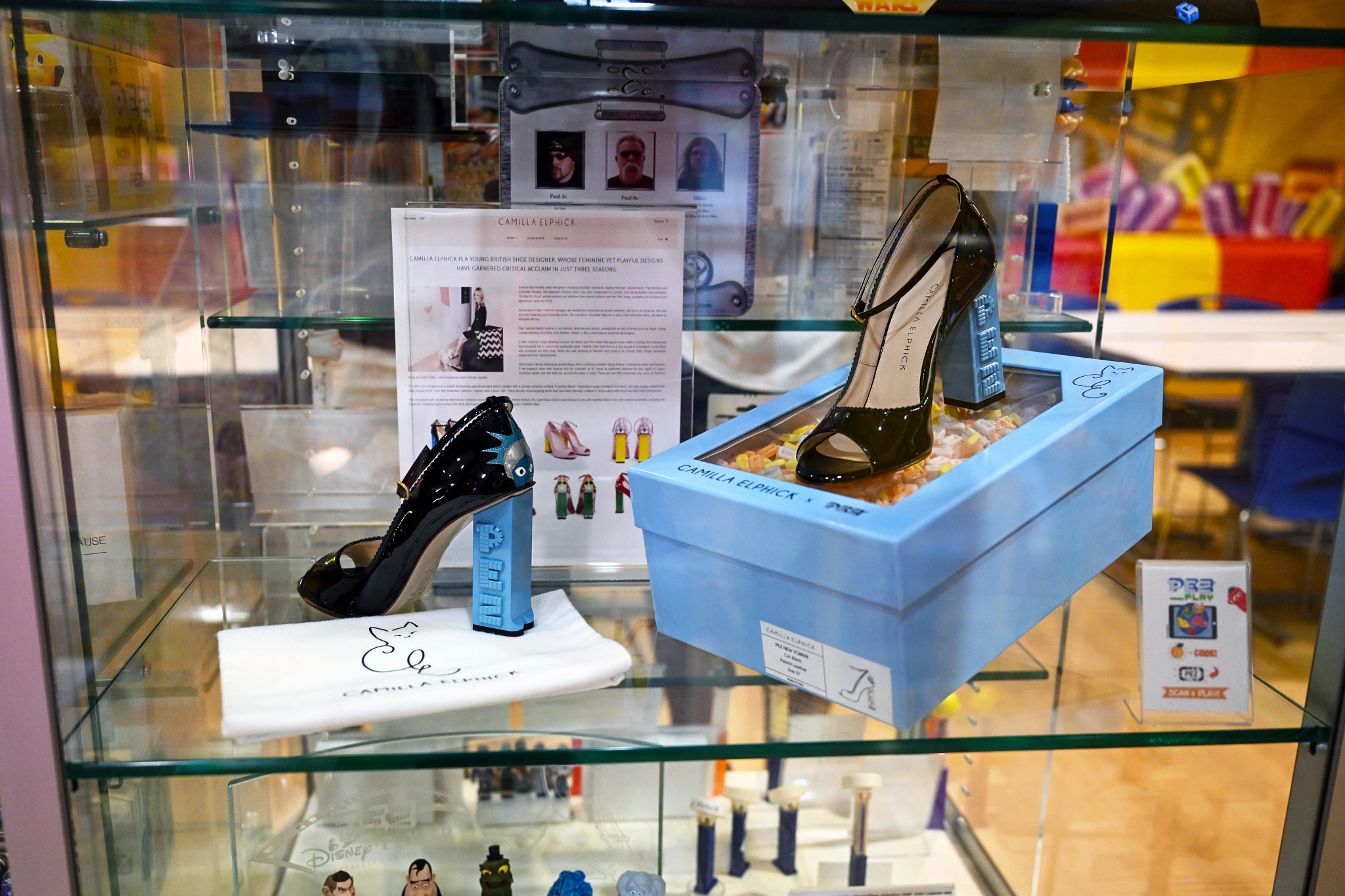 pez dispensers in the shape of shoes inside a glass case