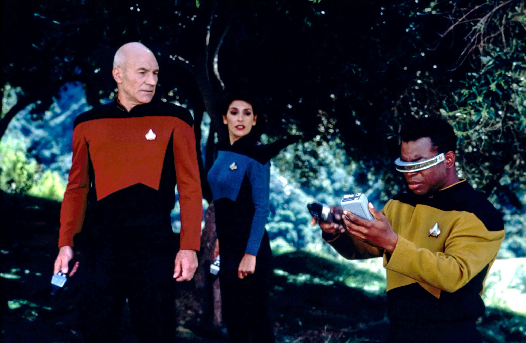 patrick stewart, marina sirtis and levar burton in a scene from an episode of star trak the next generation