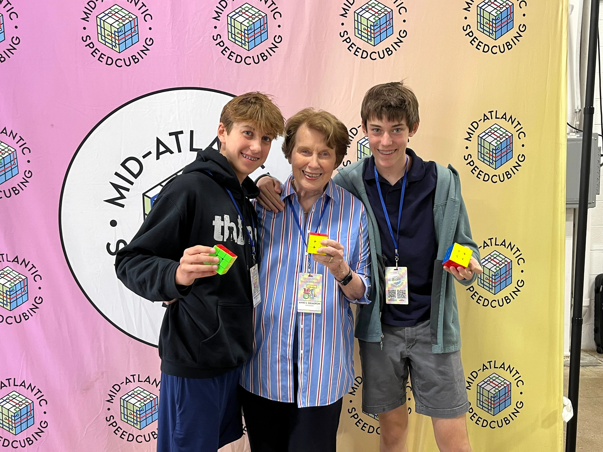A photo shows Theo, Anne and Reilly Squadron at the Mid-Atlantic Speedcubing Competition.