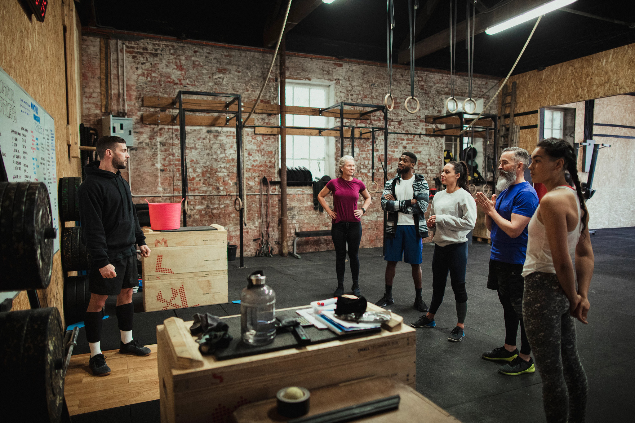 a photo shows a group of people across generations at a cross fit workout area