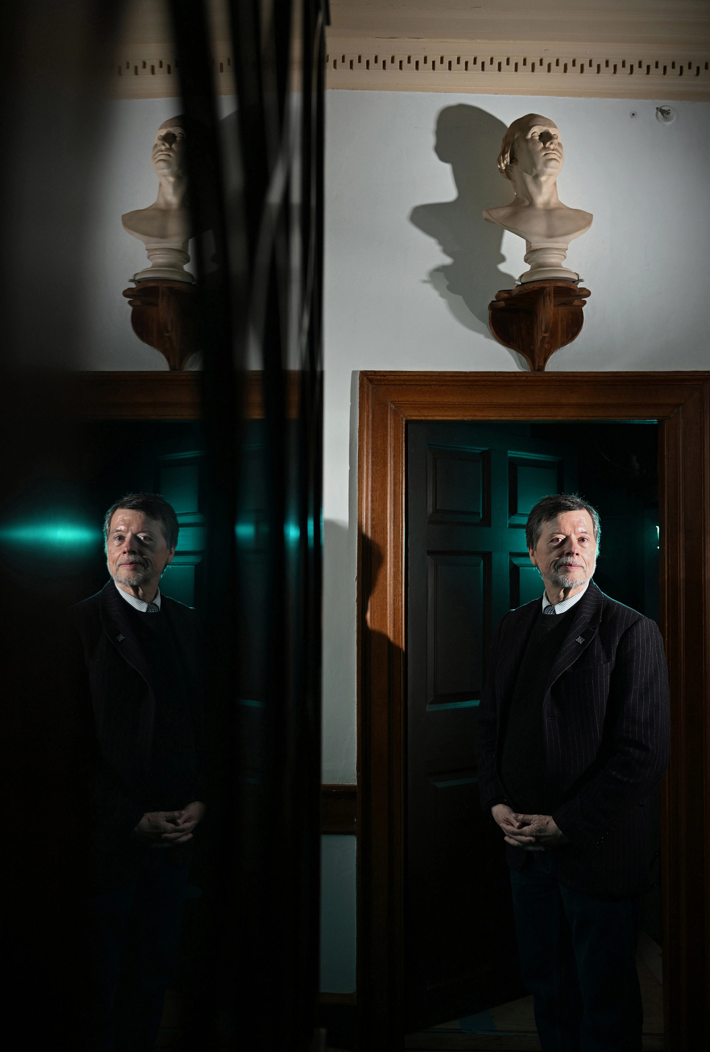 ken burns posing for a portrait in a doorway