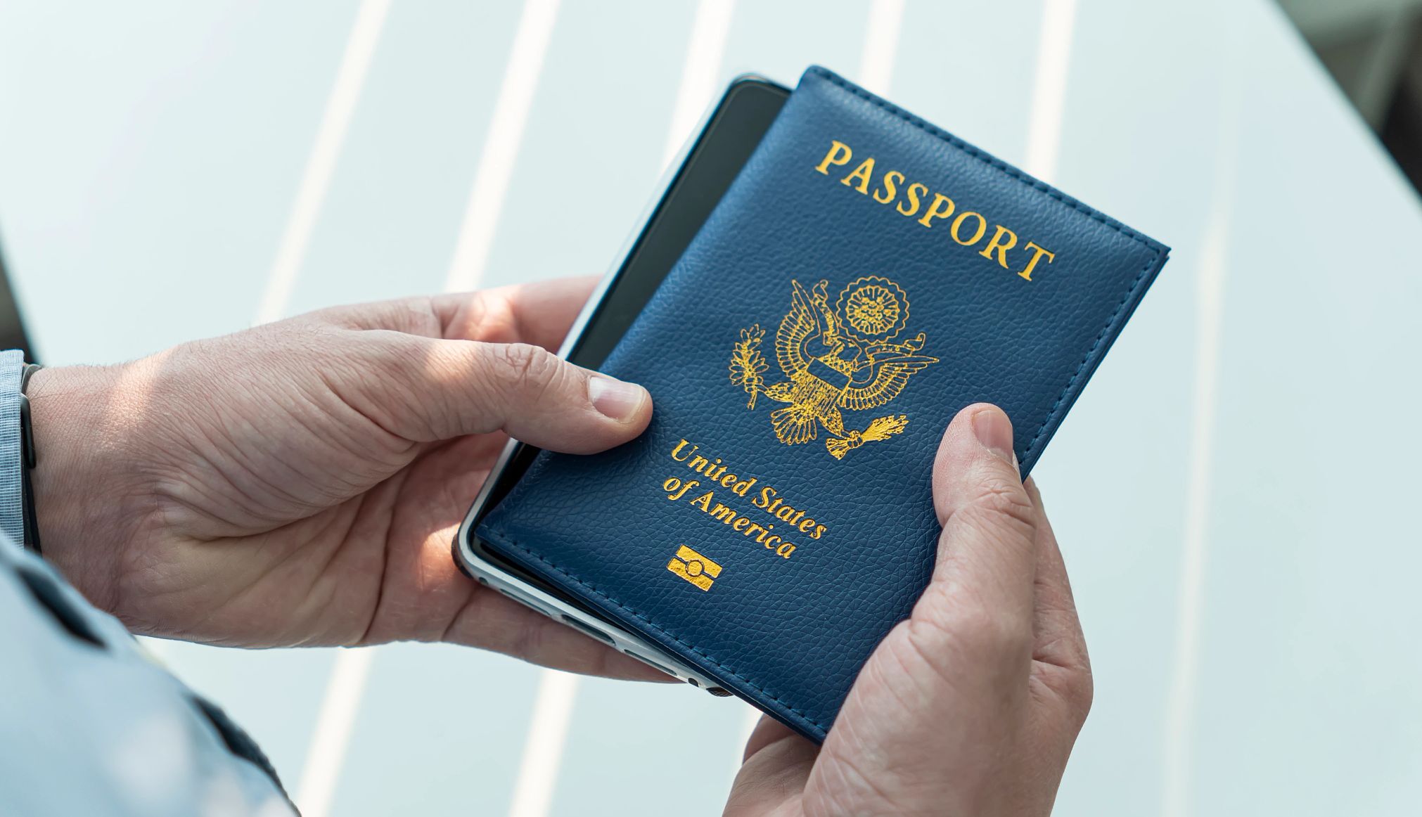 Don’t Make These Mistakes on Your Visa Application hands holding a passport