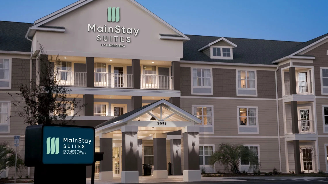 MainStay Suites® exterior of MainStay Suites hotel for extended stay, lobby entrance, sign