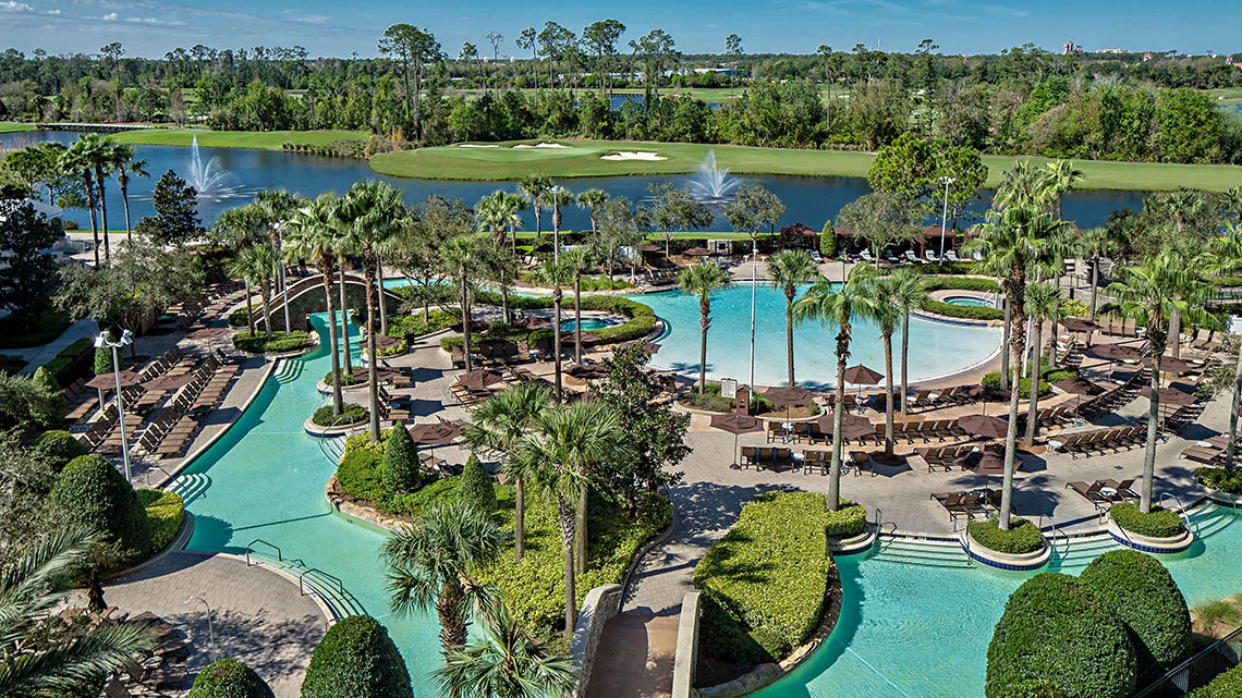 multi pool with golf course in background at hotel resort