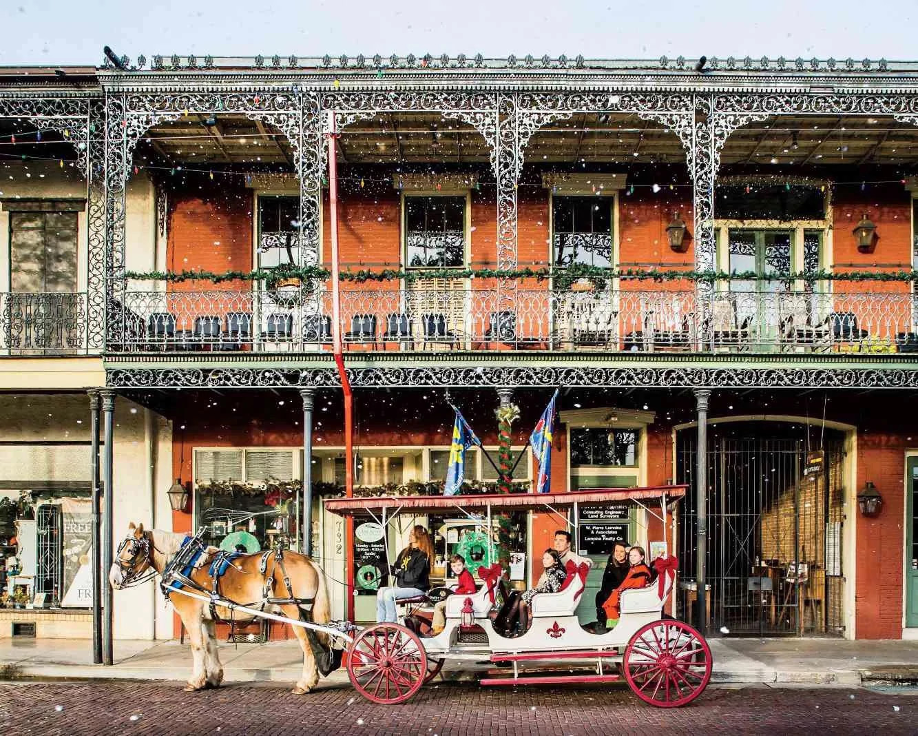 people sitting in a festive horsedrawn carriage