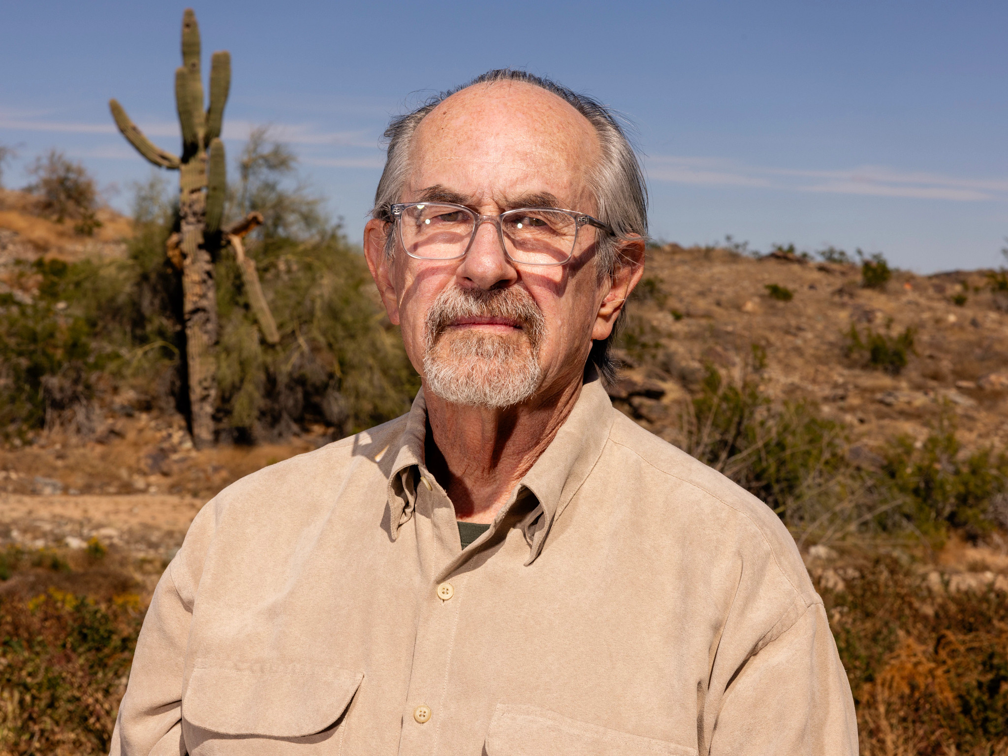 a man stands outside and looks directly at the camera