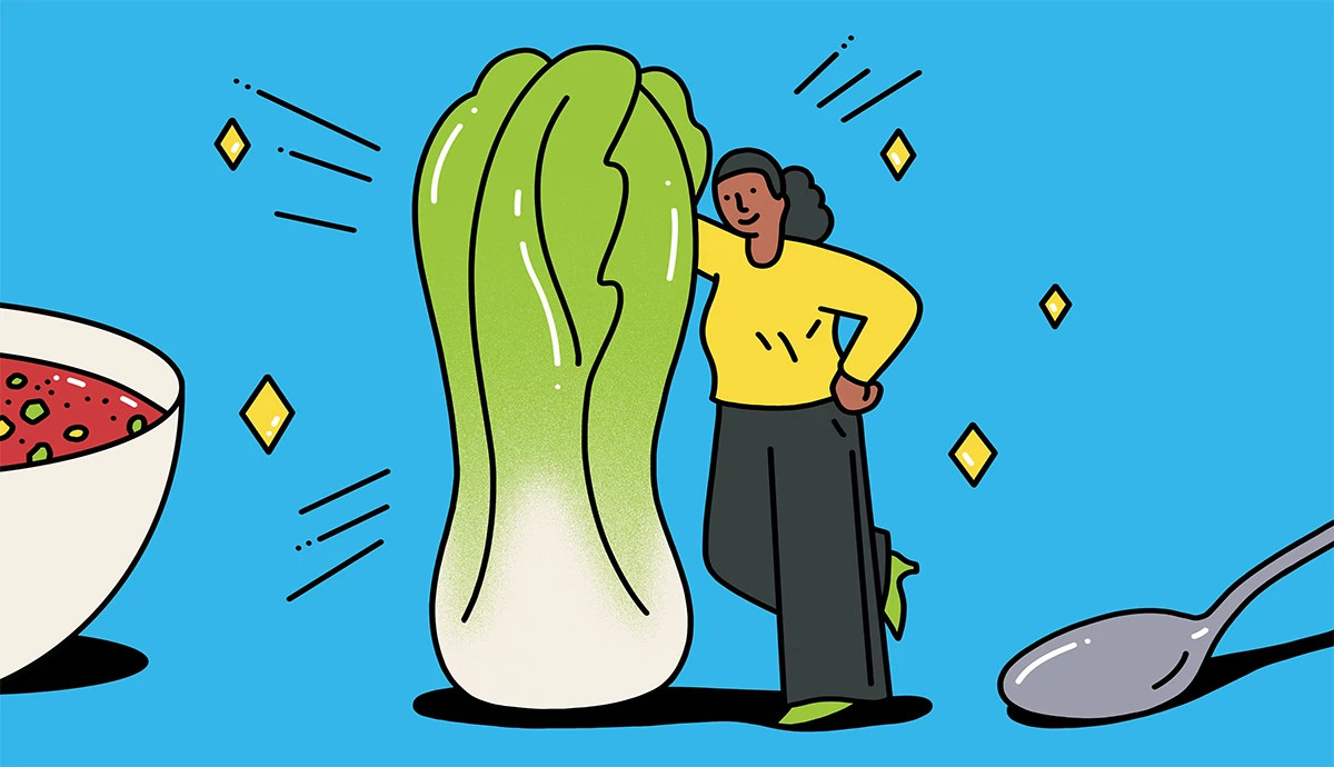 A woman leaning proudly against a giant head of bok choy
