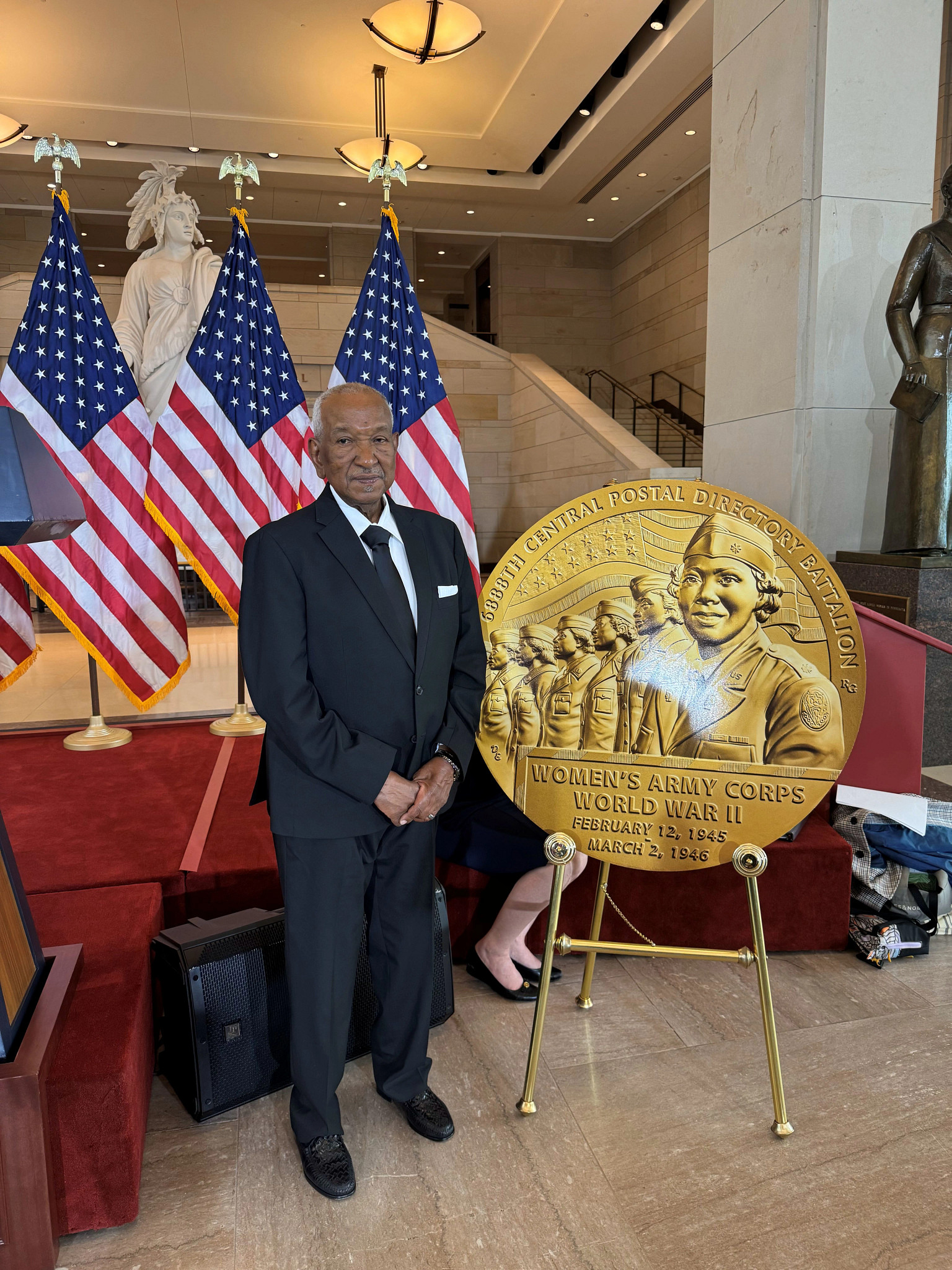 stephan hunter posing beside a memorial for the world war two womens army corps