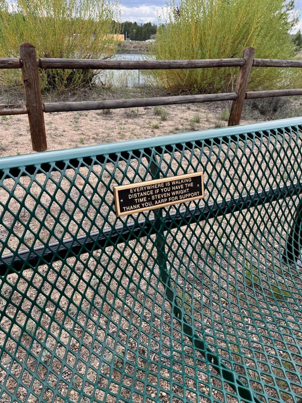 a park bench with a gold plaque in a community park