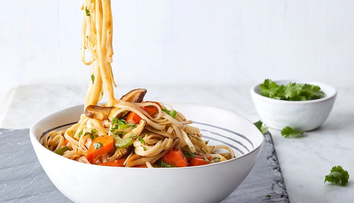 Vegetarian lo mein with shiitakes, carrots and bean sprouts A close-up view of vegetarian lo mein with shiitakes, carrots and bean sprouts in a bowl