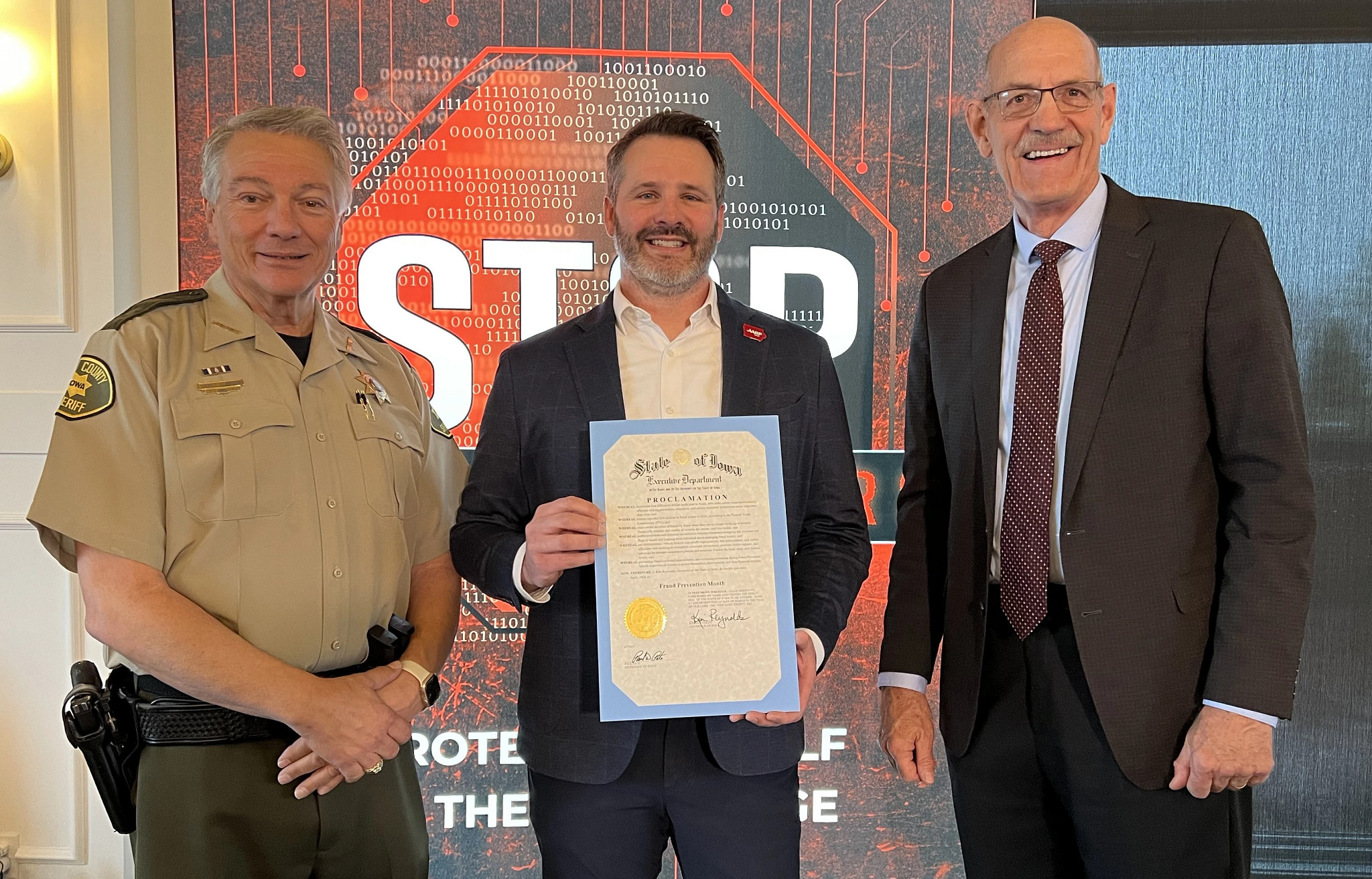 IASO Director Michael Wagler with Insurance Commissioner Ommen and Polk County Sheriff Schneider with Gubernatorial Fraud Prevention Month Proclamation