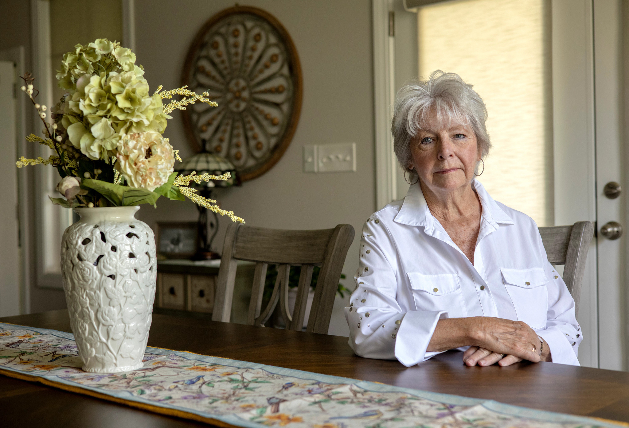 Susan Spath sits at a dining table.