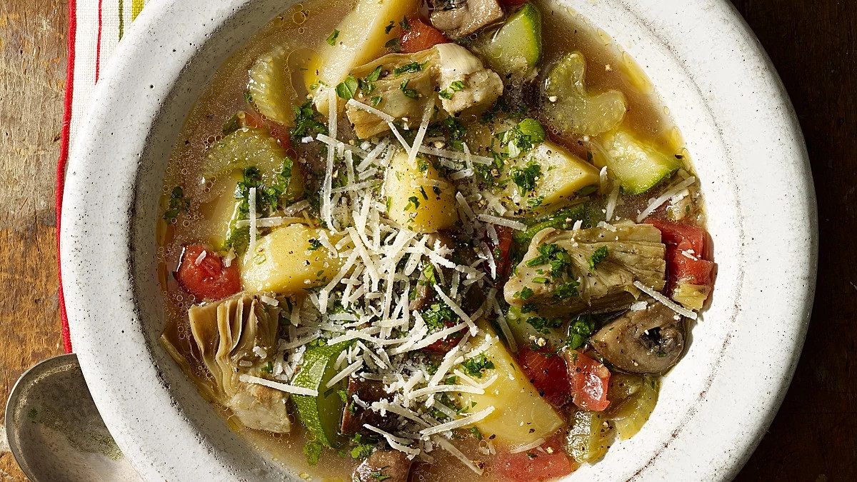 A close-up view of baked vegetable soup in a bowl