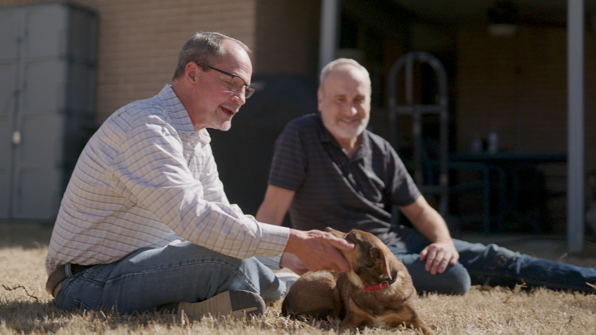 Jeffrey Woolverton plays with his dog