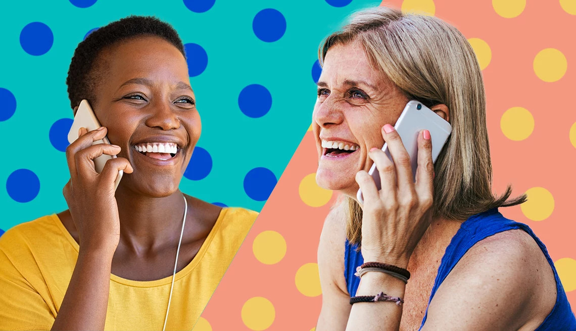 Two women talking on their phones and smiling.