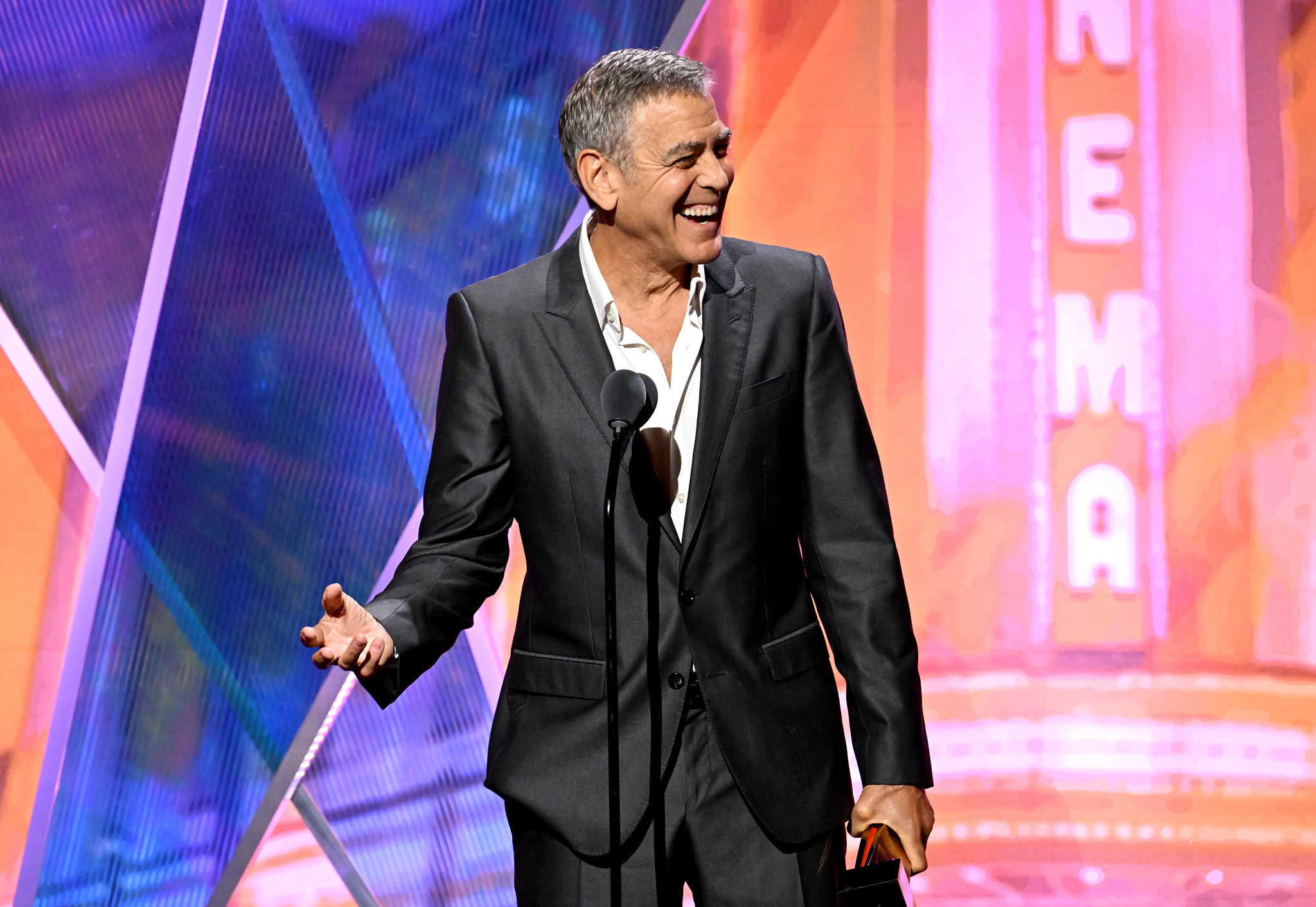 george clooney accepting an award onstage