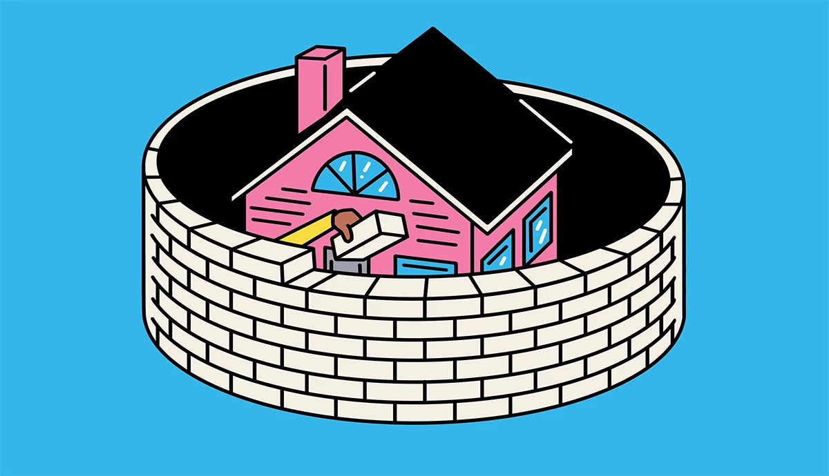 a brick wall being built in a circle around a house