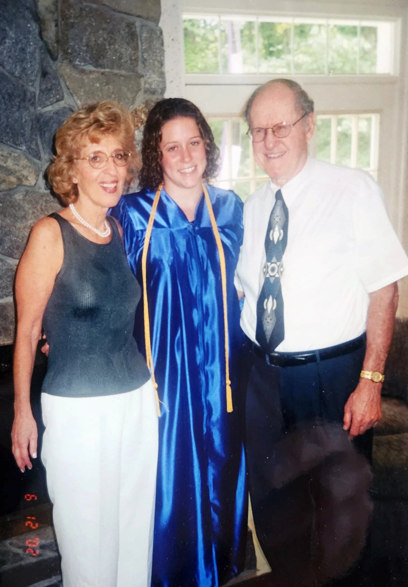 a photo shows author Rachel Azaroff celebrating her 2002 high school graduation with her grandparents