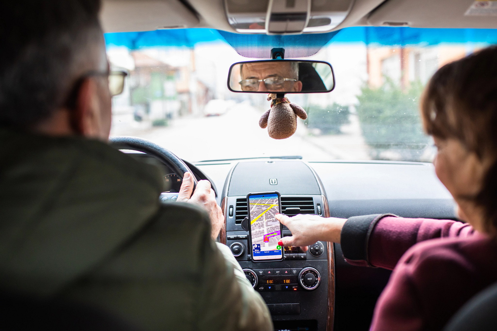 Couple in the car navigating on a map app