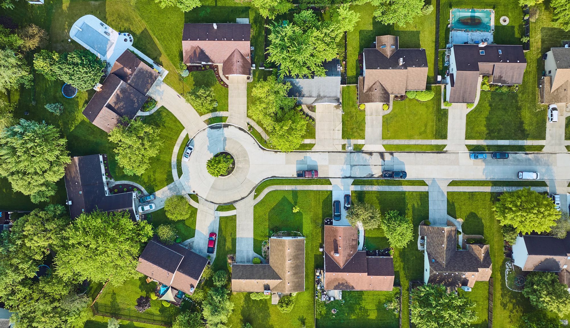 Aerial View of Middle Class Homes With Swimming Pools roof view of cul-de-sac houses in a middle class neighborhood