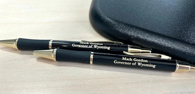 close up of pens with the inscription for the governor of wyoming mark gordon