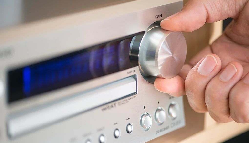 Music can engage the brain and boost well-being An up-close view of a hand during the dial on a radio