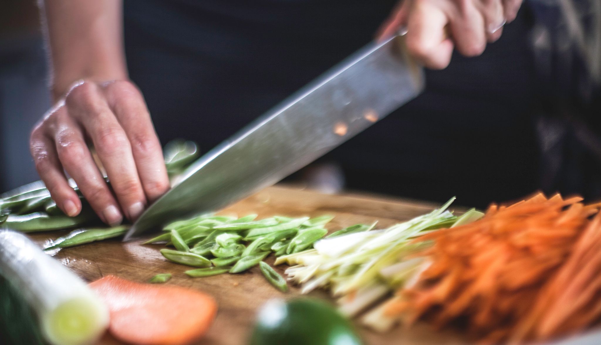 Image of a knife cutting vegetables Image of a knife cutting vegetables