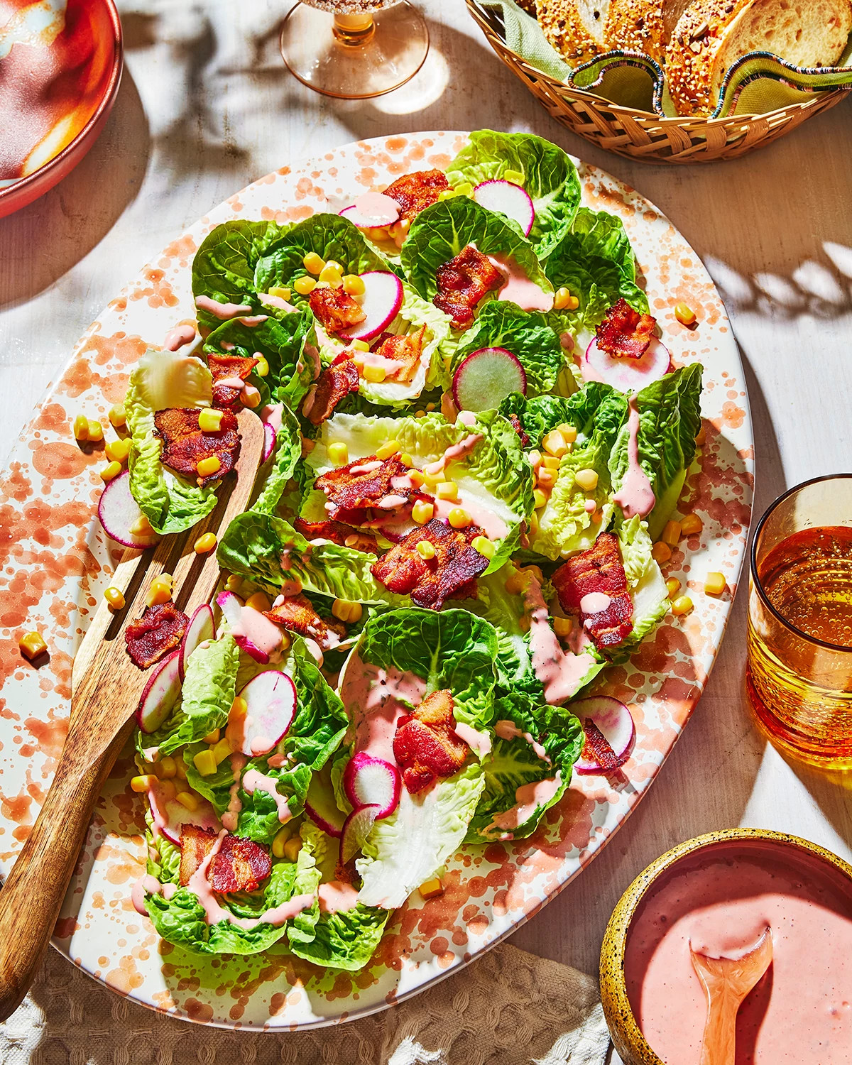 Colorful bacon and corn salad with strawberry basil dressing served on a platter