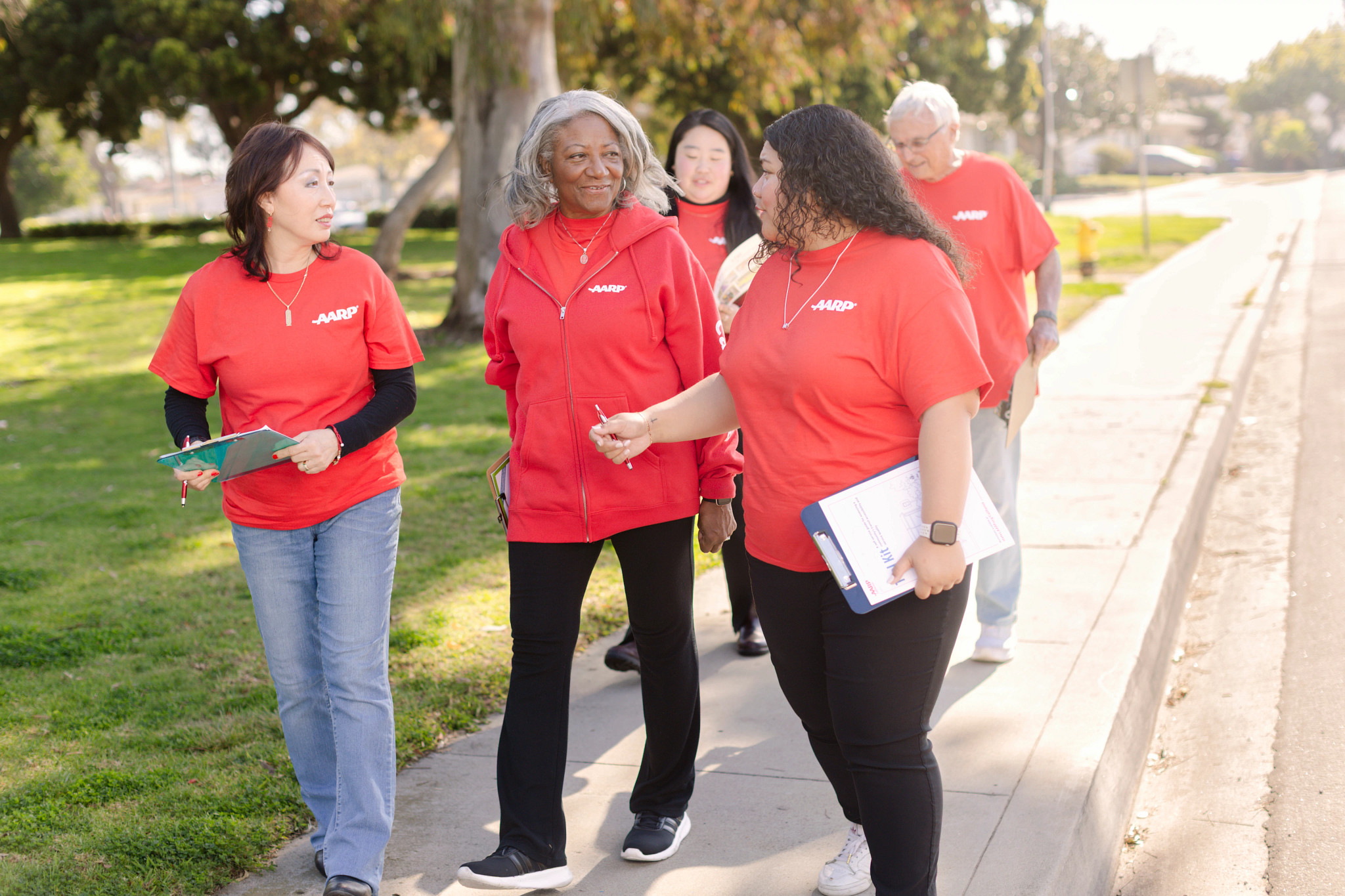 AARP volunteers conduct a neighborhood walk audit, gathering observations that help identify opportunities to improve safety, accessibility, and walkability in the community. Pictured in photo: Cynthia K, Holly Zhang, Tiffany Zhang (staff), Bob Prath and Shanyce S. 