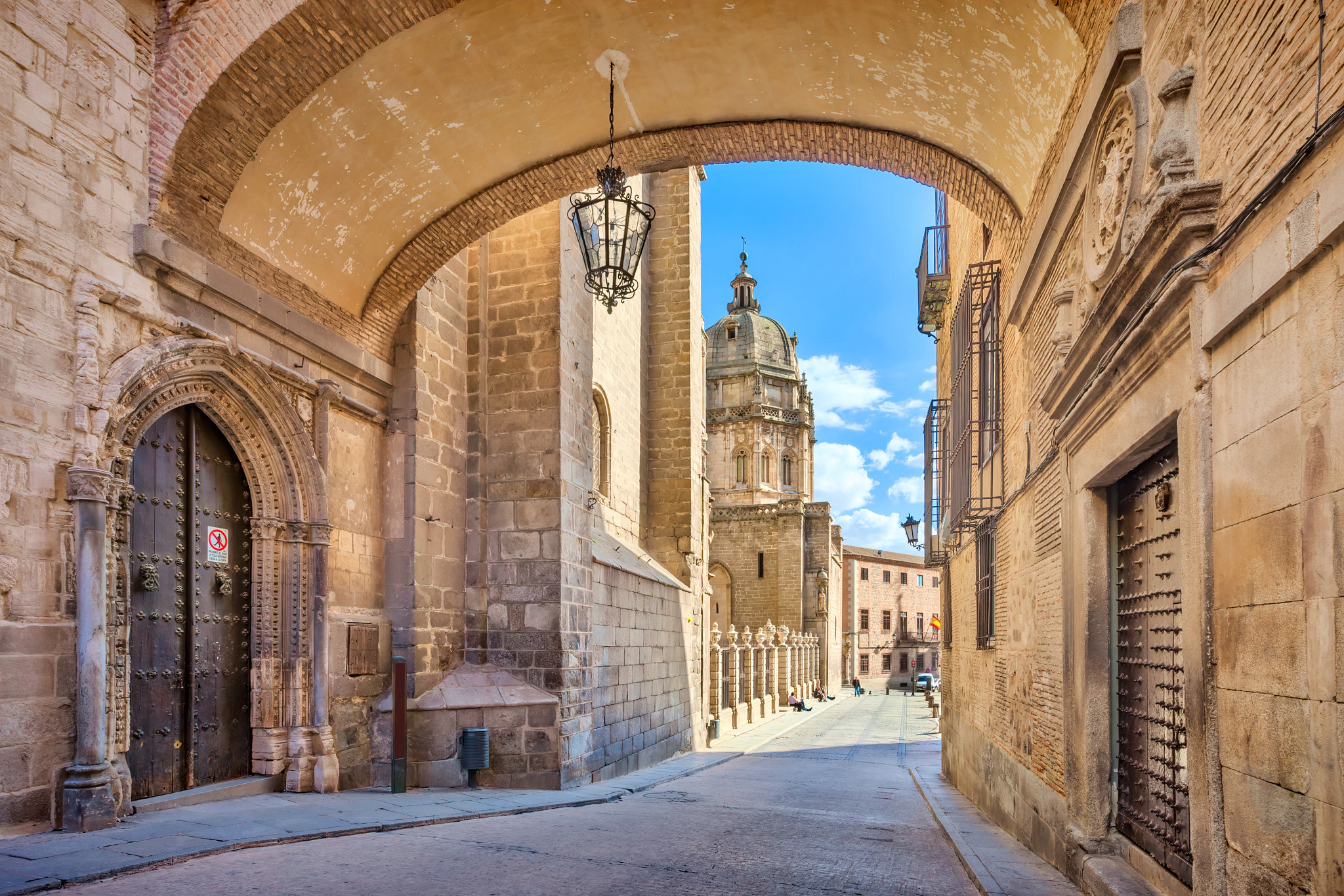 a street leading to the toledo cathedral